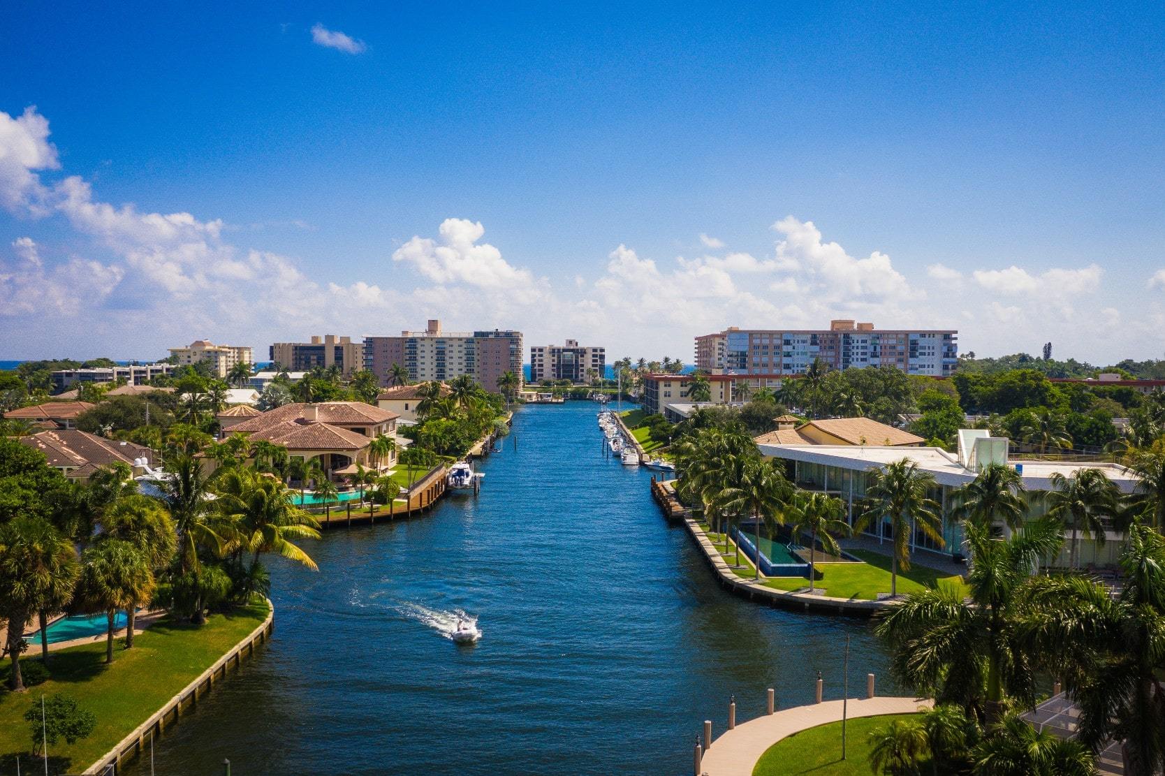 Aerial view of a canal lined with waterfront real estate in Lighthouse Point, Florida